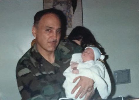 Veteran Lawrence Saucier holds his newborn daughter while stationed at Fort Campbell in Kentucky.